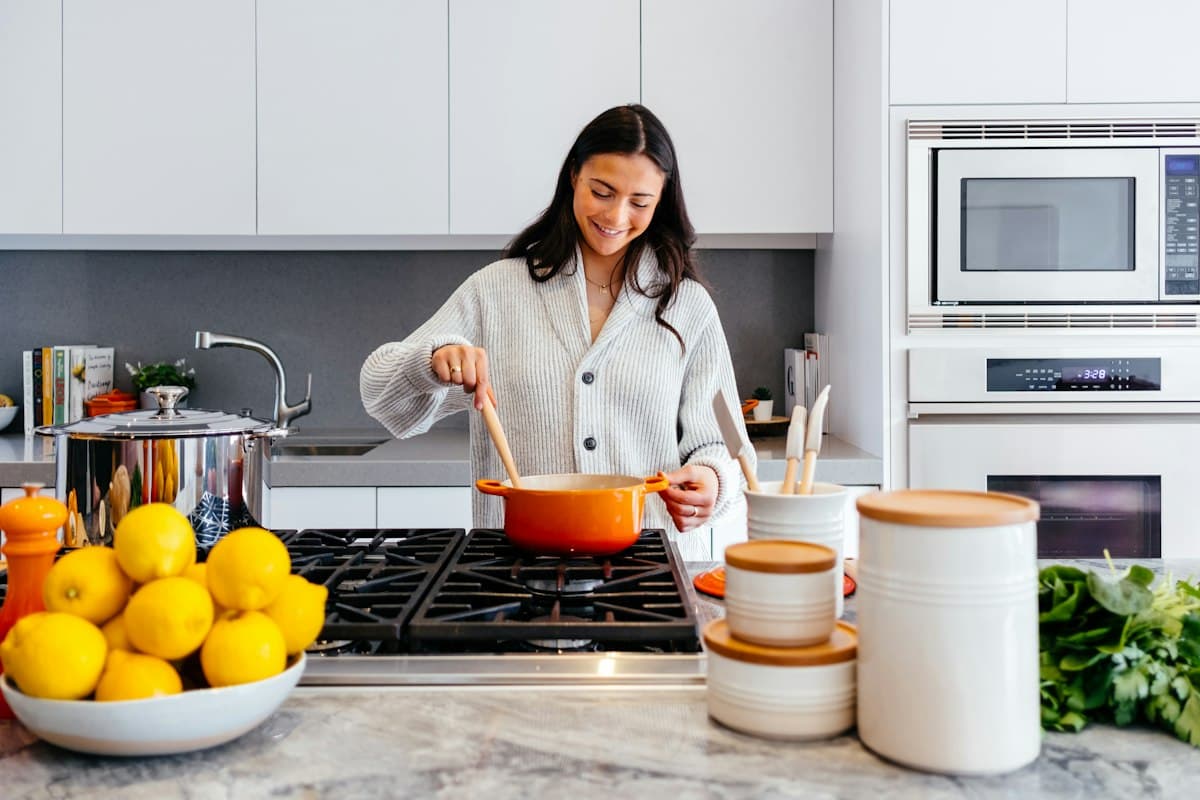 Kitchen baking scale with measuring cups and fresh ingredients on marble countertop