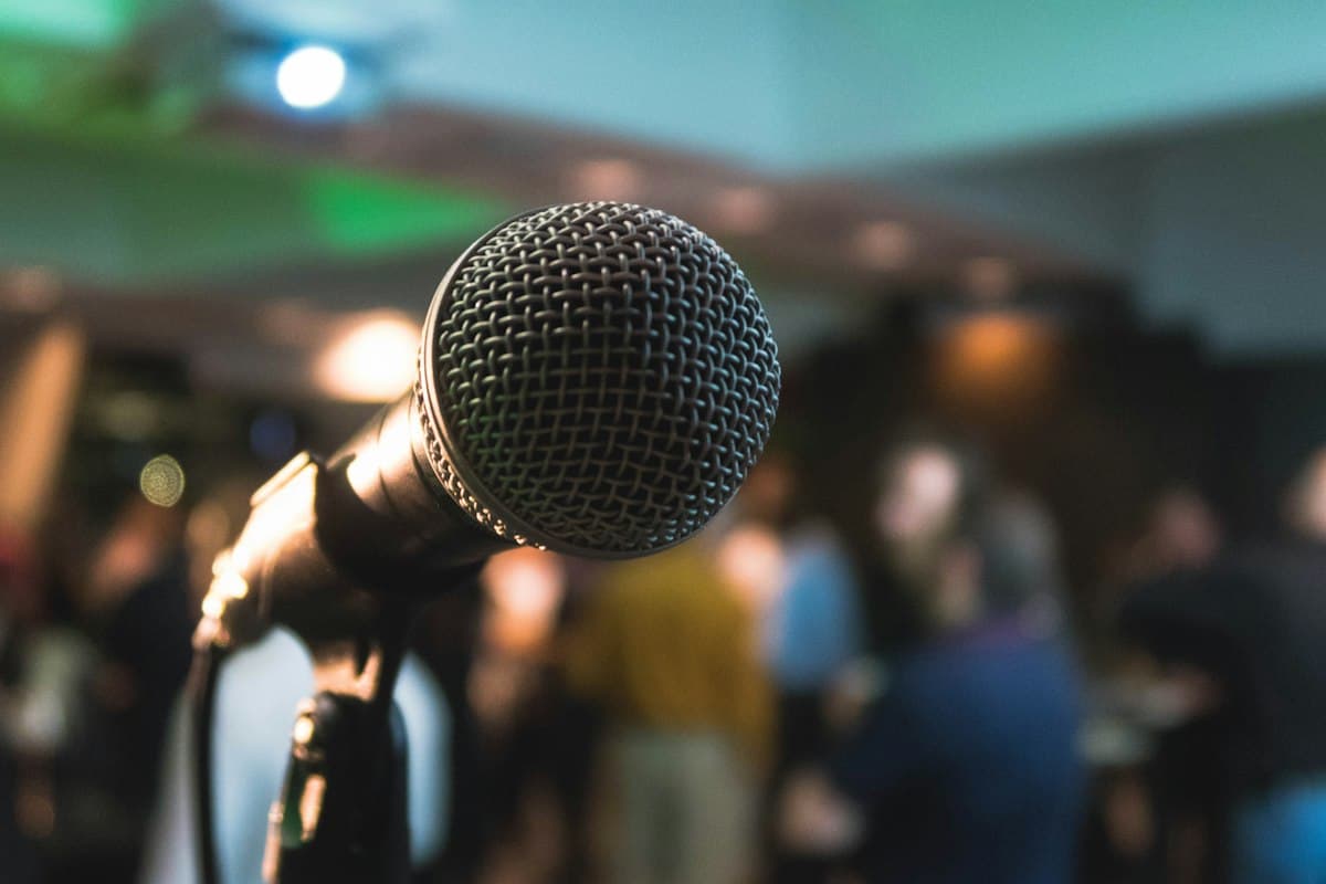 Professional presentation stage microphone illuminated under keynote conference lighting