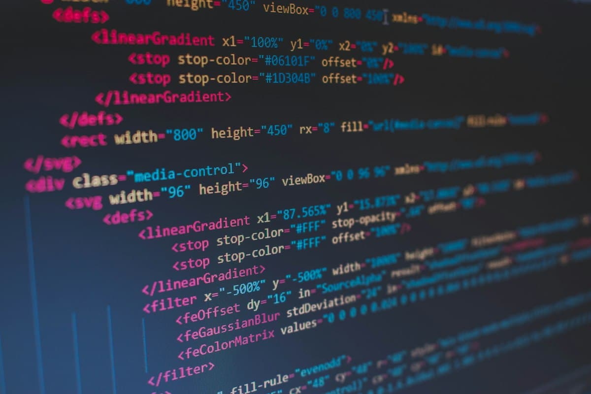 Developer writing software code and fixing syntax bugs on a computer
