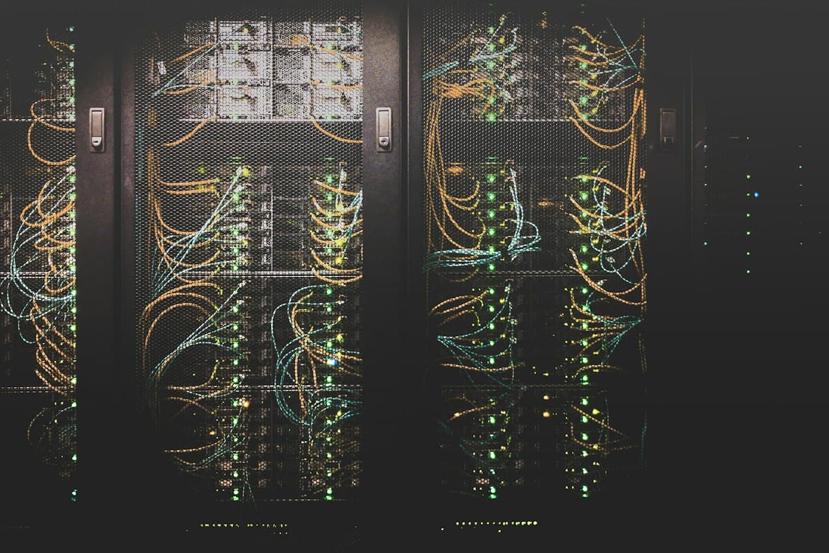 Server rack illuminated with fiber optic network cables in a secure modern datacenter