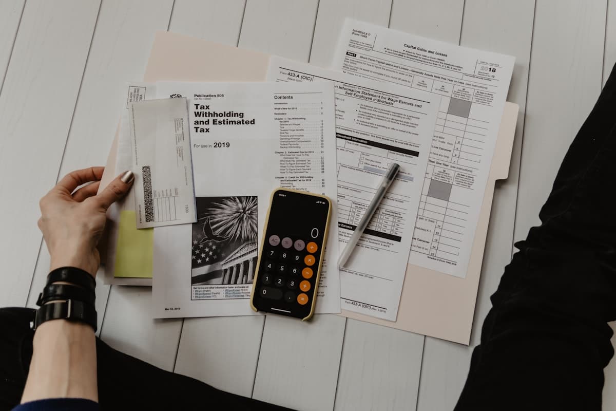 Financial ledger notebook with fountain pen and modern desk calculator