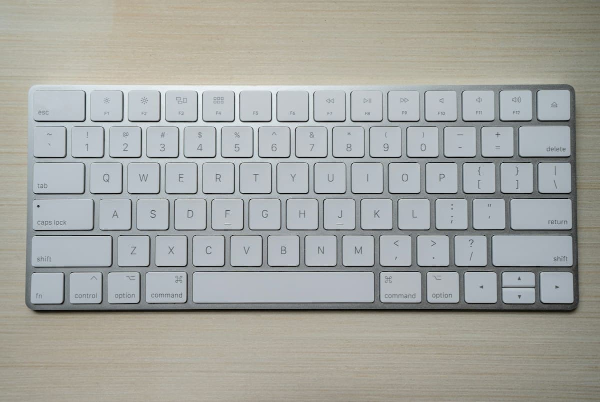 Clean illuminated mechanical keyboard on dark developer coding desk