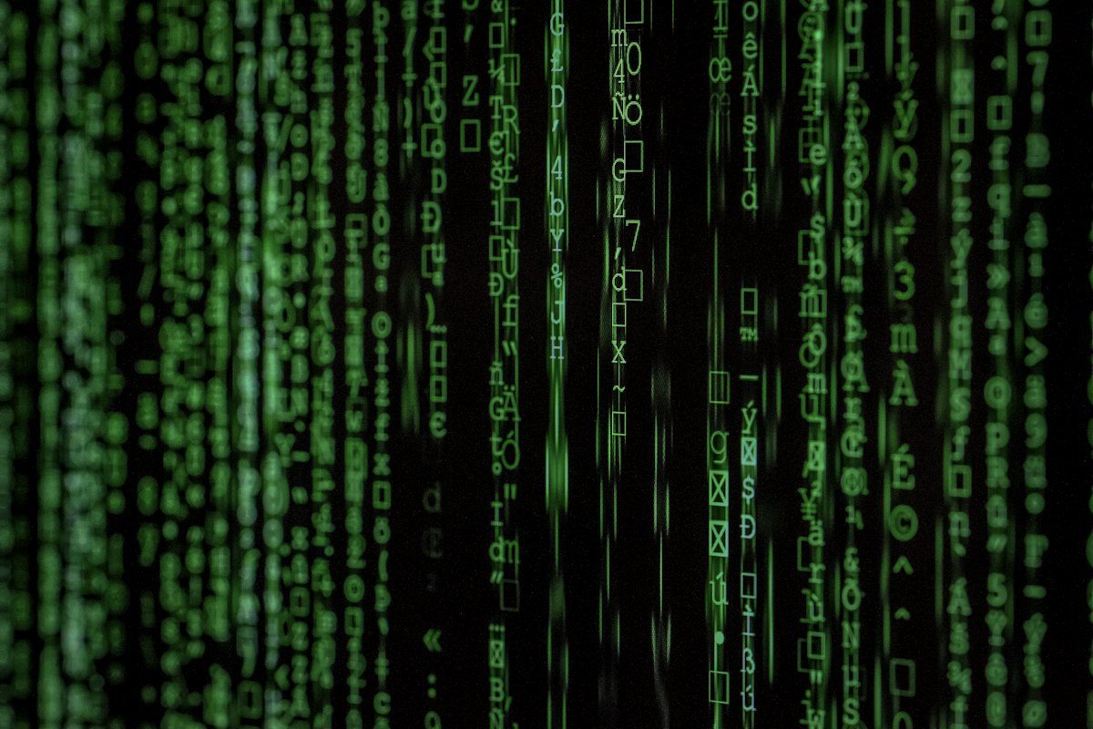 Green digital binary code on a black computer screen