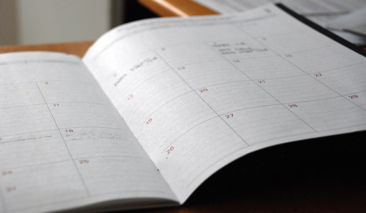 Remote work desk with international time zones, calendar planner, and coffee