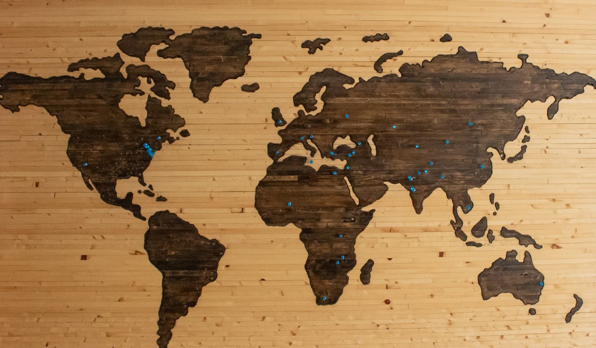 World globe surrounded by international text manuscripts