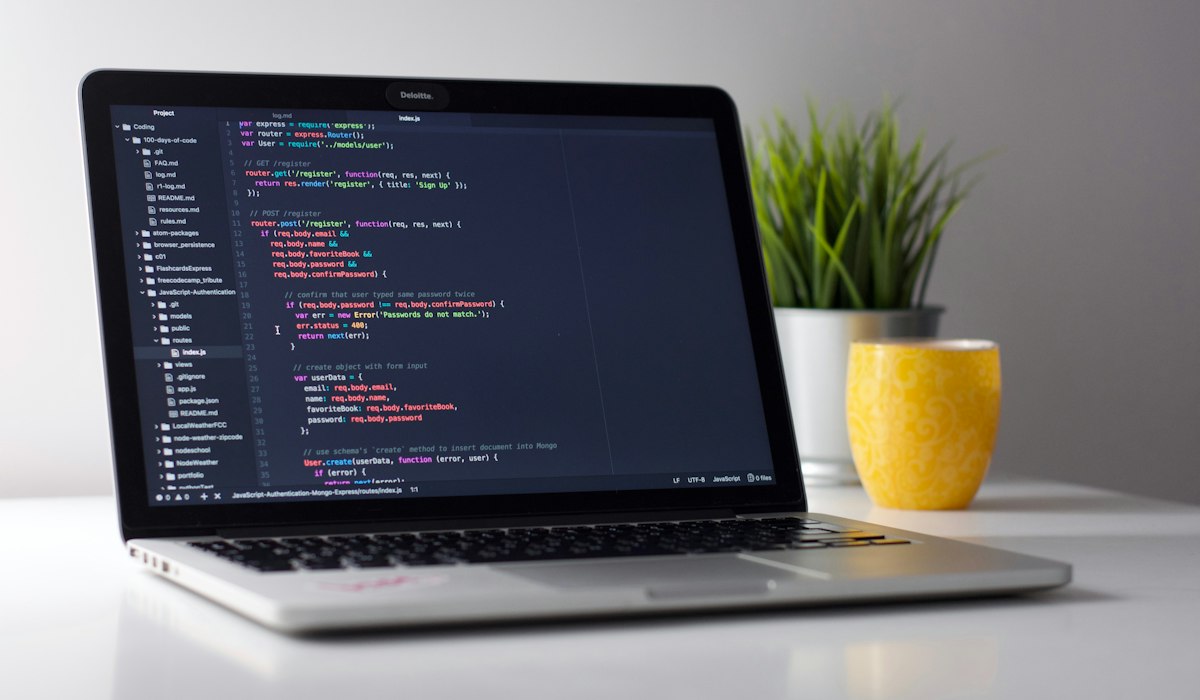 Developer debugging regular expressions and source code on laptop